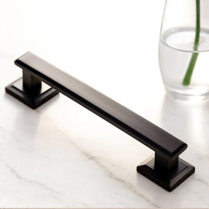 TIDLO 96 black outdoor pull handle placed on a marble white surface