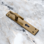 TIDLO 502 Half Handle satin sheen gold placed on a circular marble surface