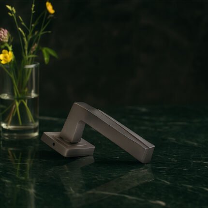 KEPA 501 silver door handle placed on a green marble surface