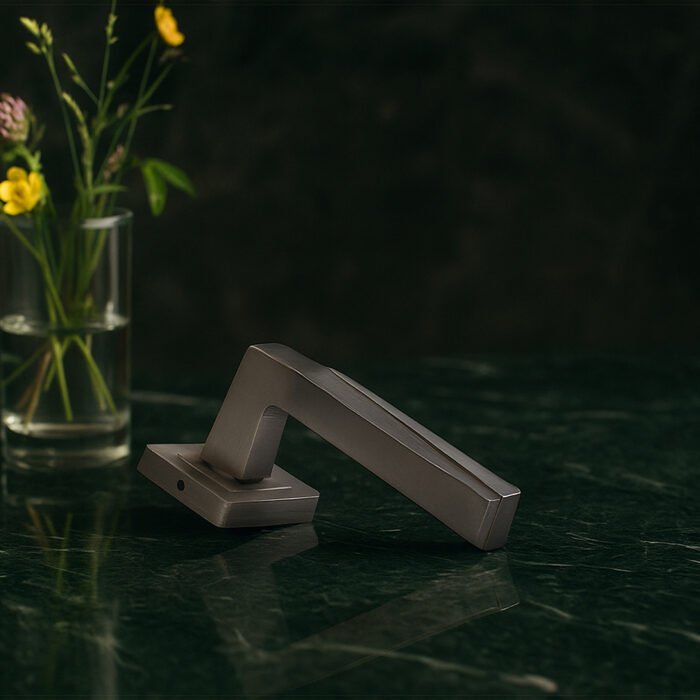 KEPA 501 silver door handle placed on a green marble surface