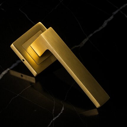KEPA 505 gold door handle placed on a black marble surface