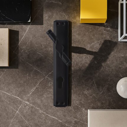SQIEK 551 Half-Handle Black placed on piece of marble surrounded by dark gold flat stainless bowl and a yellow cube