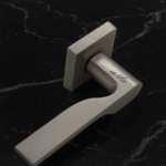 KEPA 502 silver rosette handle with the name Laila engraved. Placed on a black marble surface