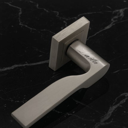 KEPA 502 silver rosette handle with the name Laila engraved. Placed on a black marble surface