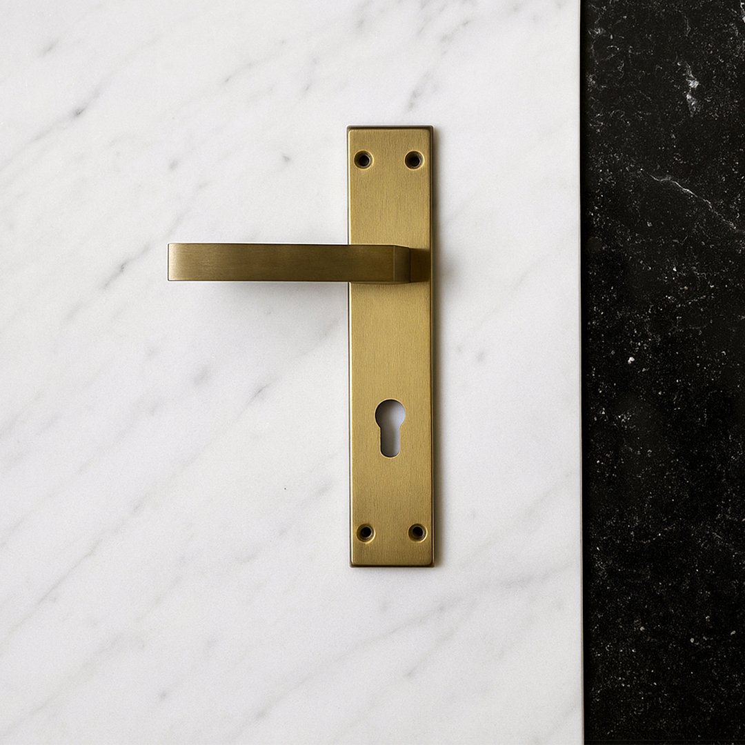 TIDLO-505-Gold-Thumbnail TIDLO 505 backplate Gold cylinder door handle placed on a white marble surface
